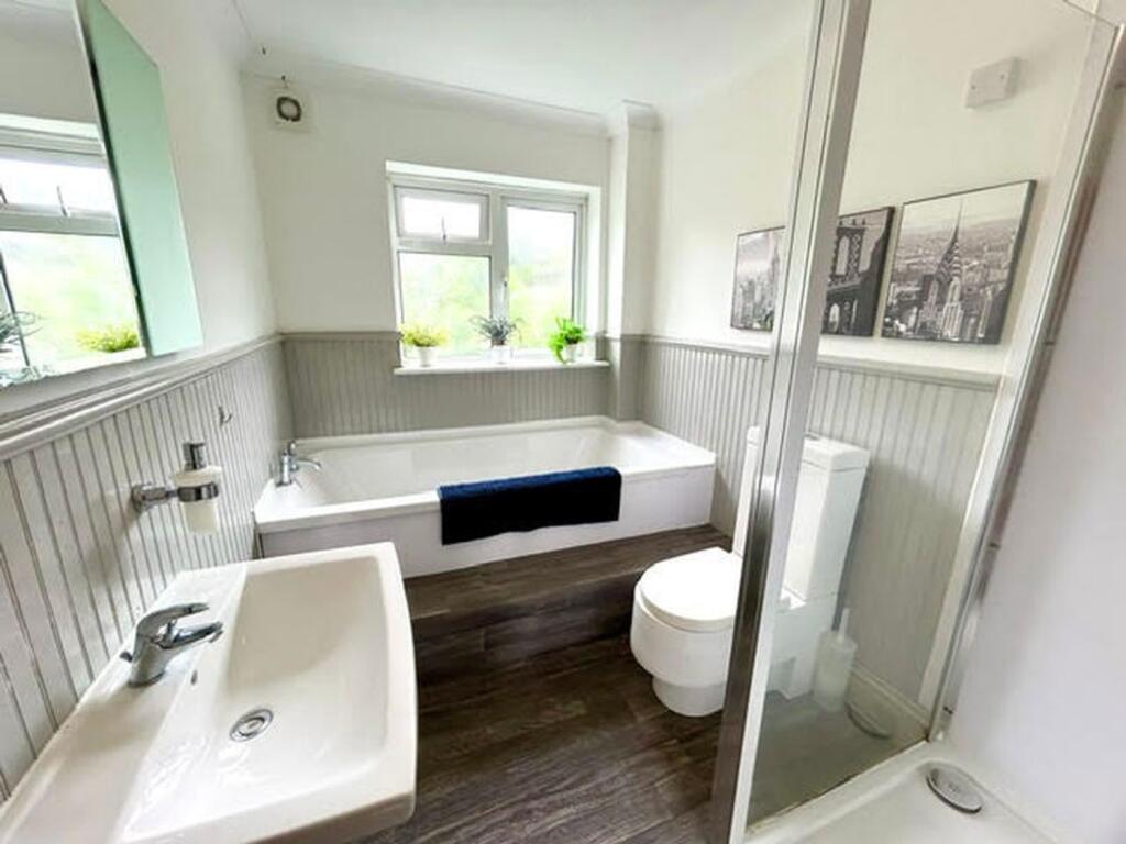 A spacious and well-lit large bathroom featurin...