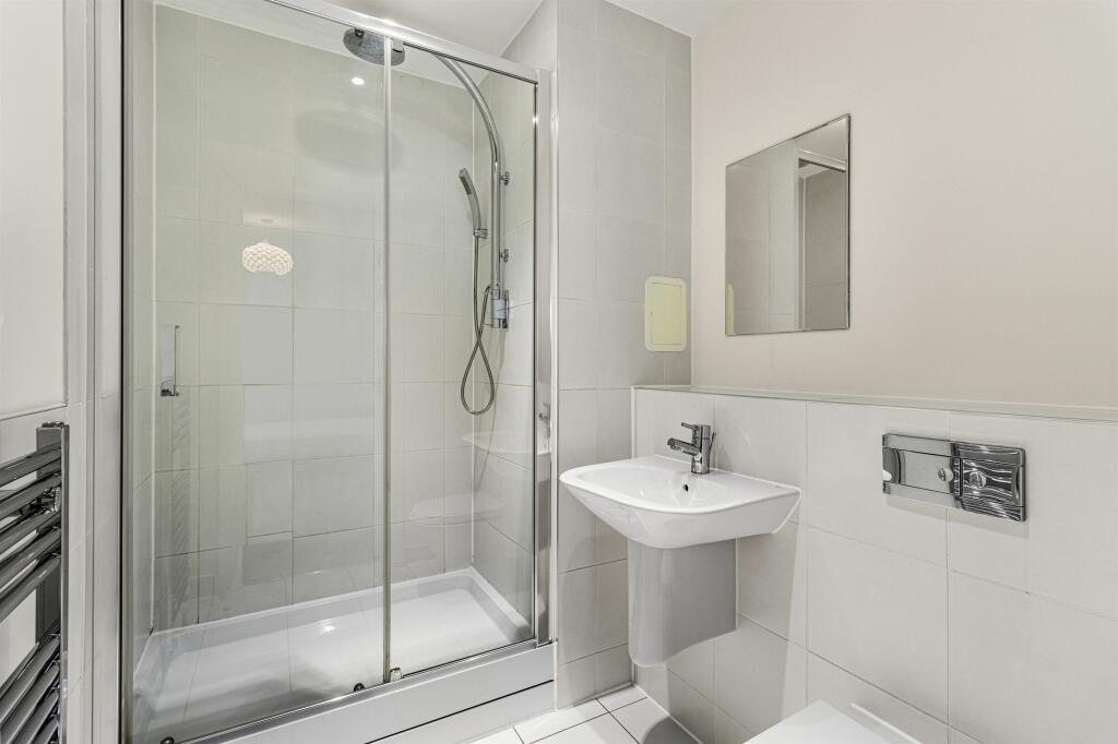 Experience luxury in this sleek and modern bathroom with high-end finishes.