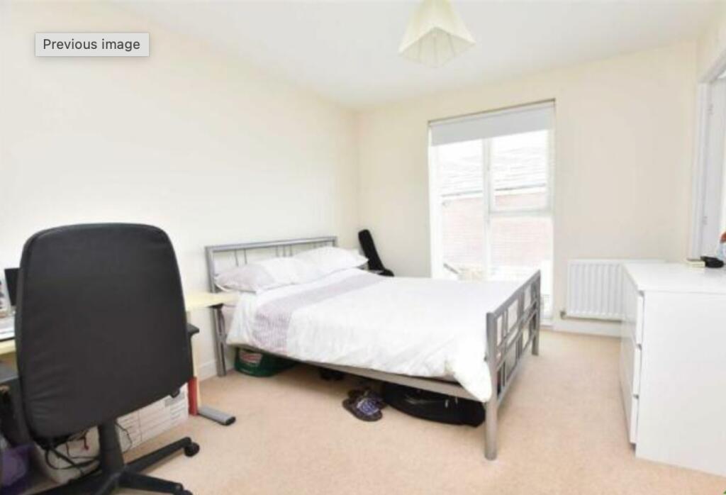 Bright and spacious master bedroom featuring a ...