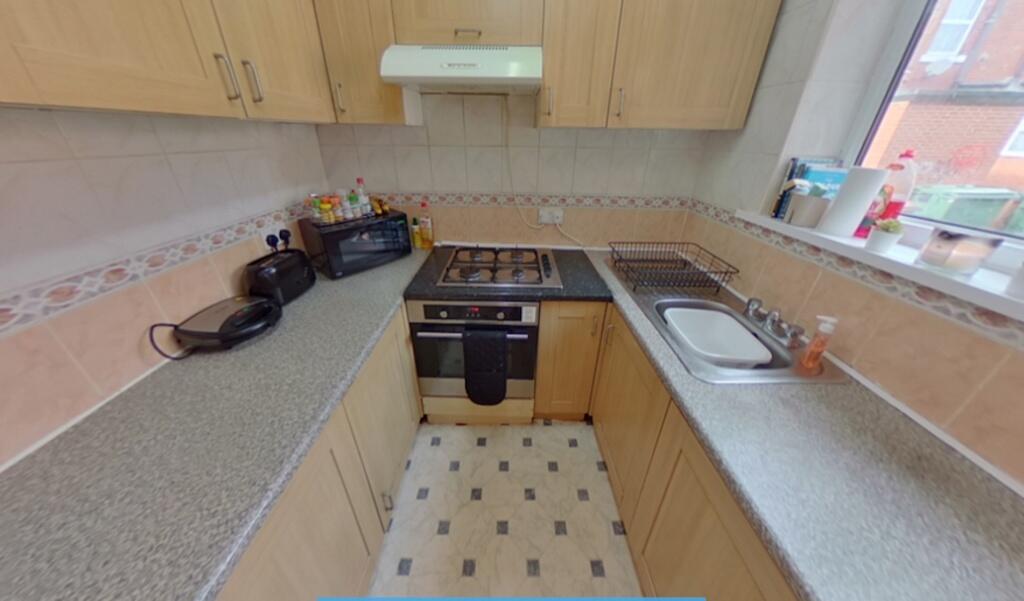 A clean and functional kitchen featuring wooden...