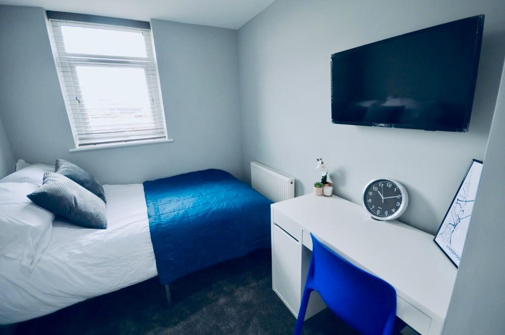 This inviting double bedroom features a cozy la...