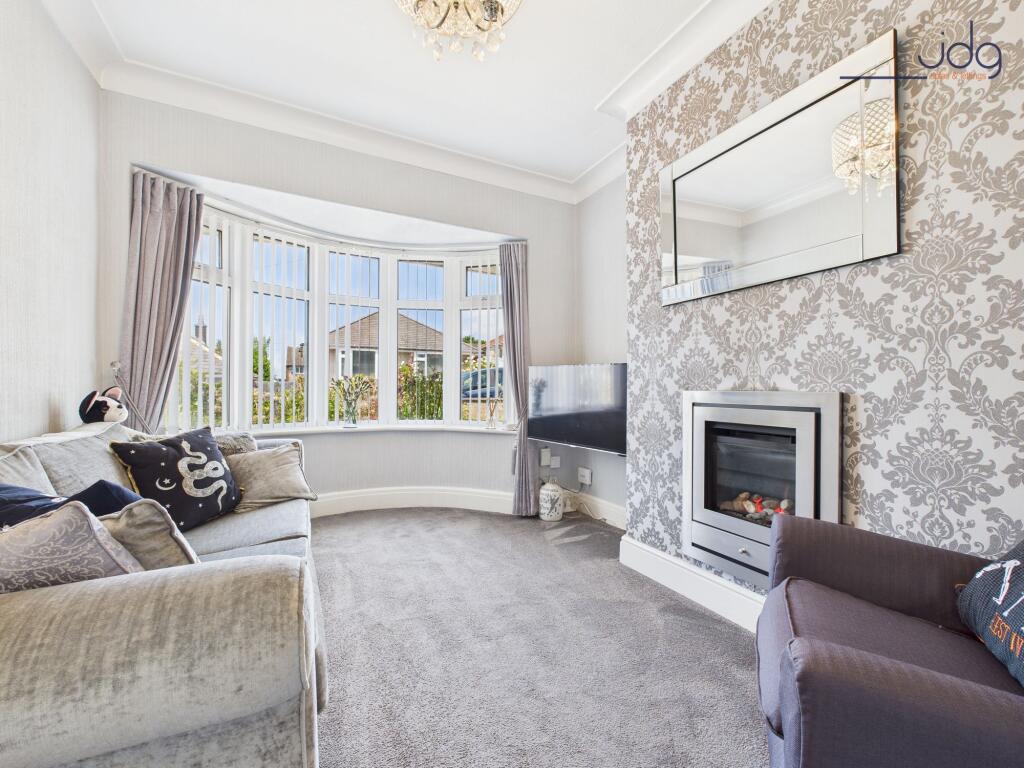 Lounge with bay window and a modern feature fireplace