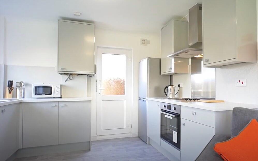Modern kitchen featuring sleek cabinetry and am...