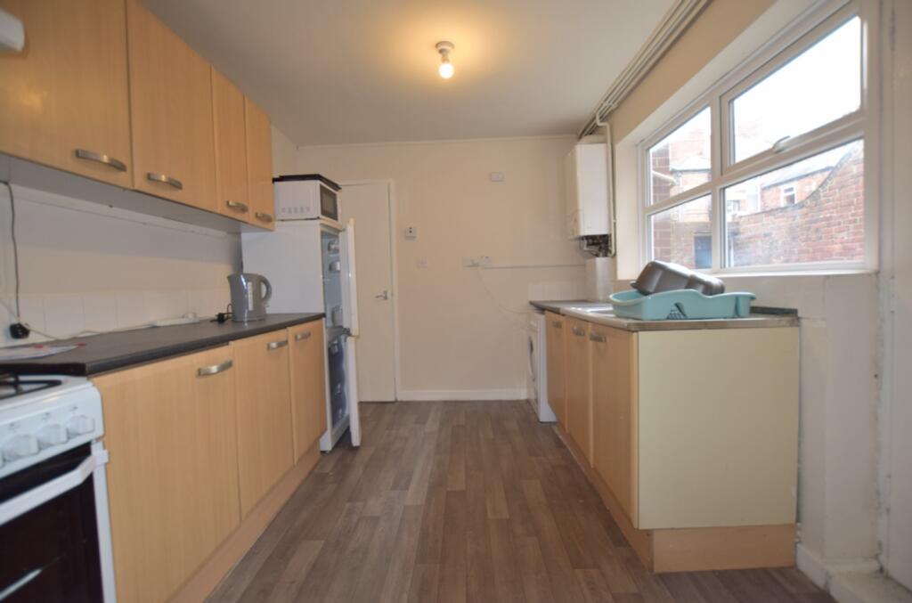 A spacious and practical kitchen with ample sto...