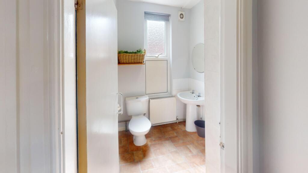 A bright and tidy bathroom featuring essential ...