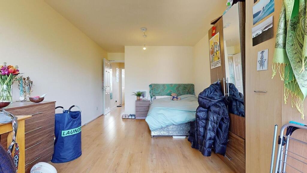 A neatly arranged double bedroom with a comfort...