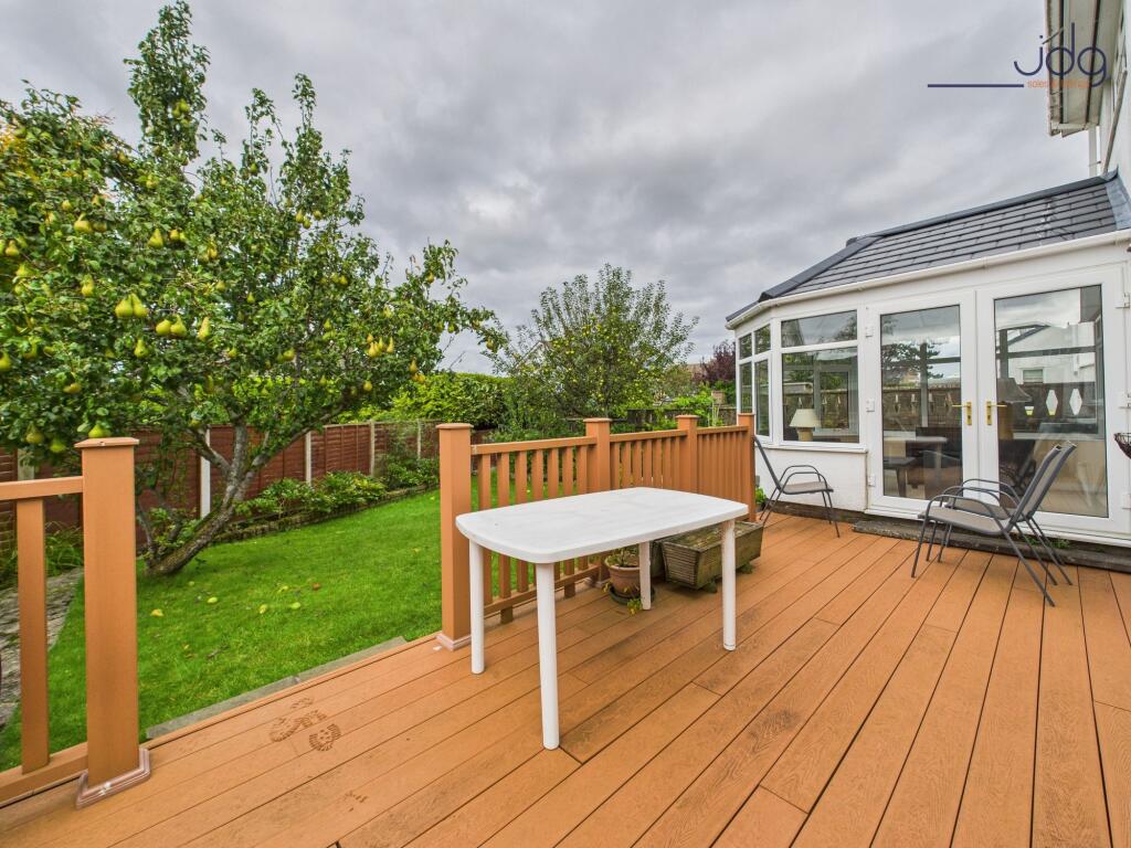Spacious garden to the rear of the property with decking and fruit trees