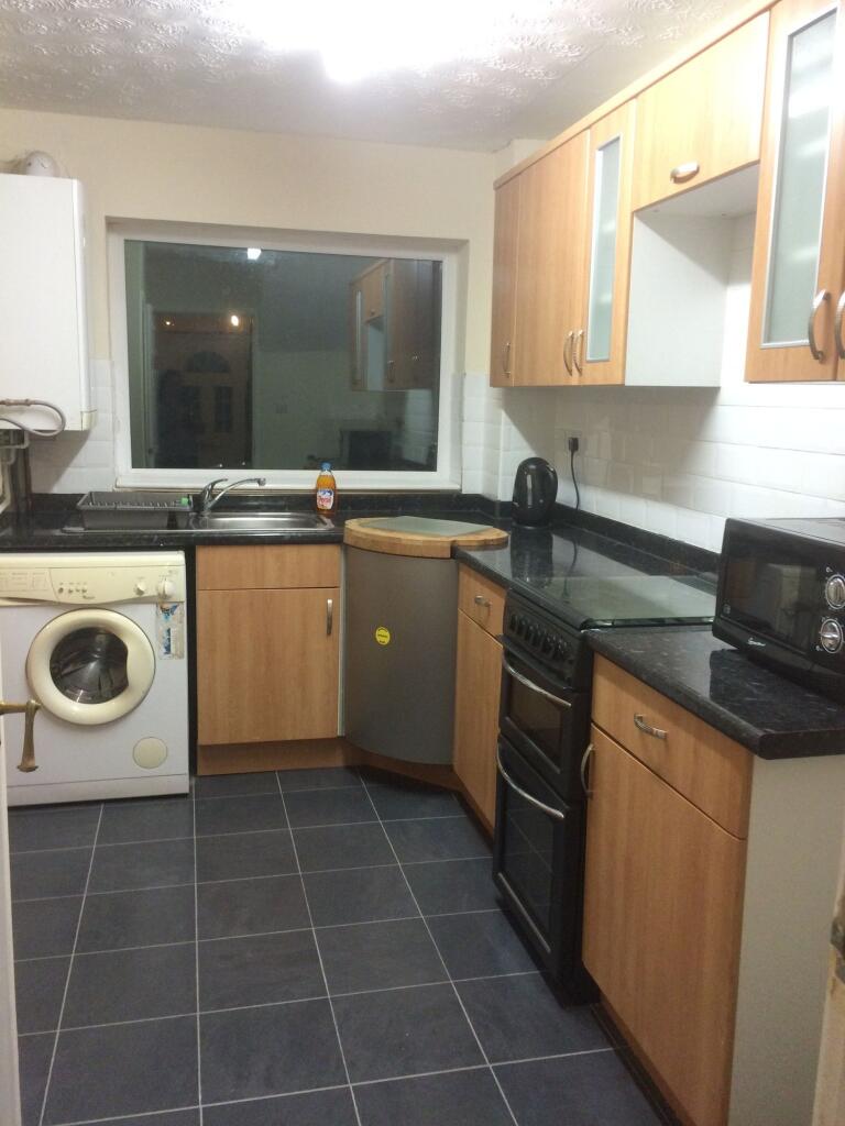 A neat and functional kitchen featuring modern ...