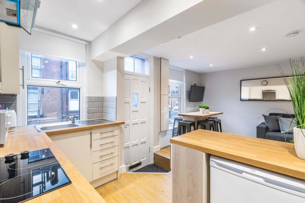 A bright and modern kitchen with ample natural ...