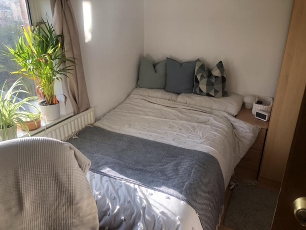 A spacious and bright double bedroom with moder...