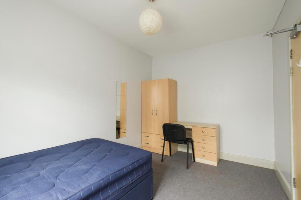 Bright and spacious double bedroom featuring a ...