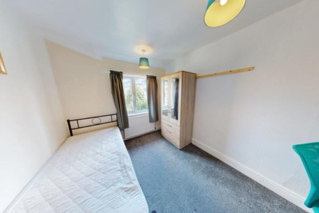 A bright and inviting double bedroom featuring ...