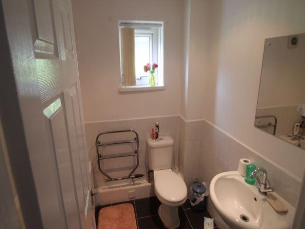 A clean and functional small toilet with a whit...