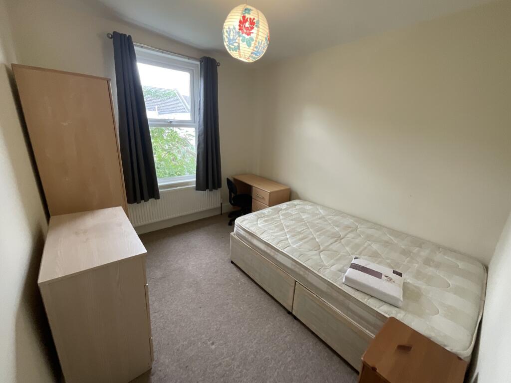 A neat and simple single bedroom with a well-ma...
