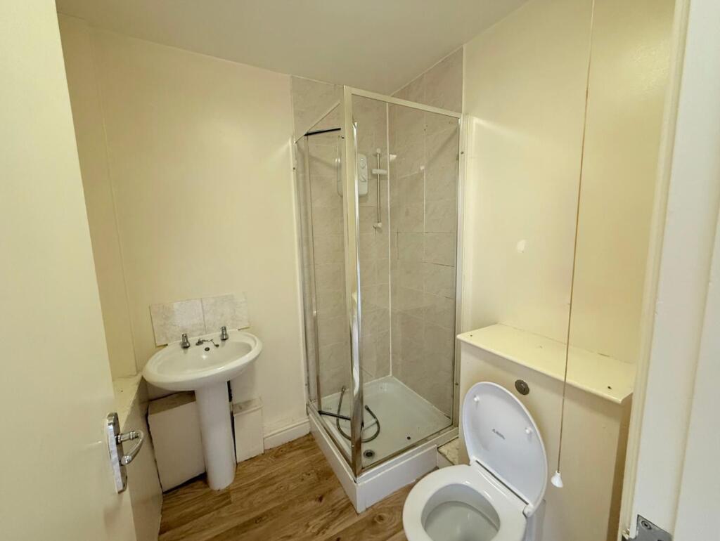 A functional bathroom featuring a shower cubicl...