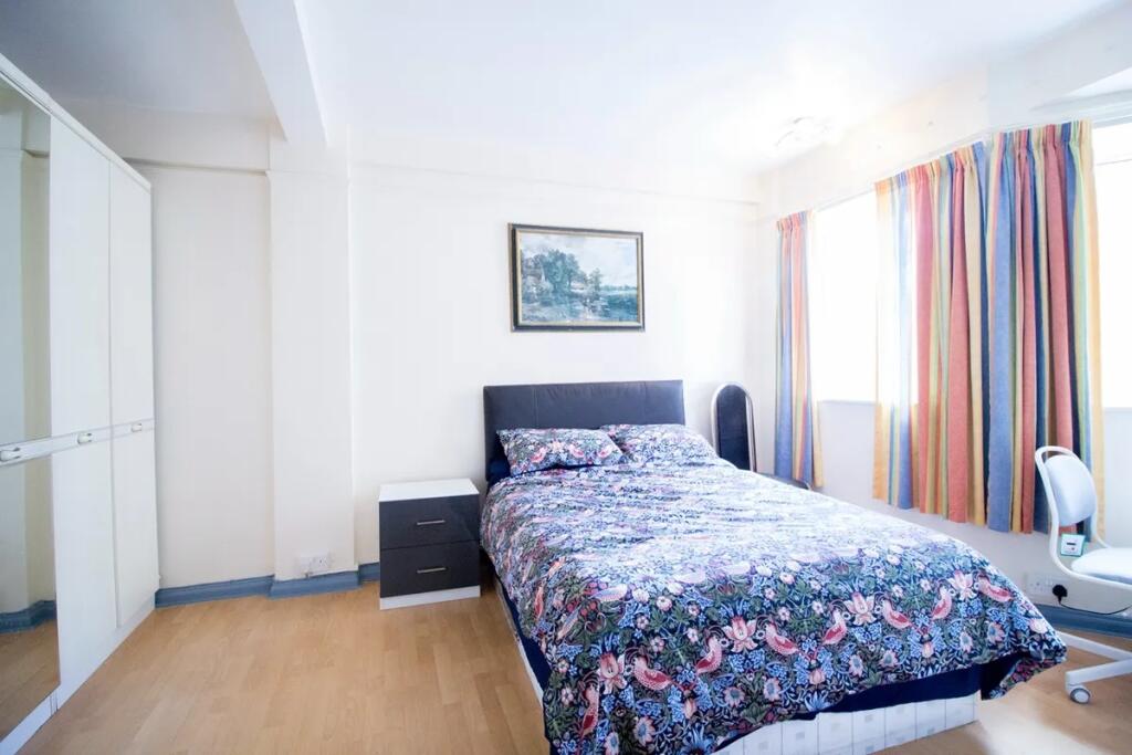 Bright and welcoming double bedroom featuring a...