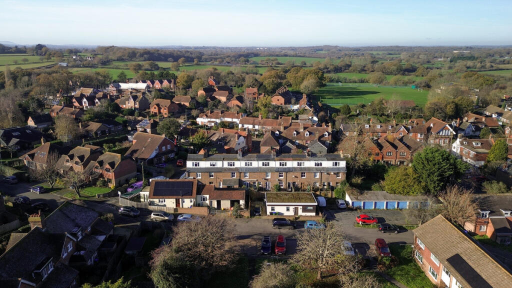 Aerial view over the house and open countryside and walks beyond
