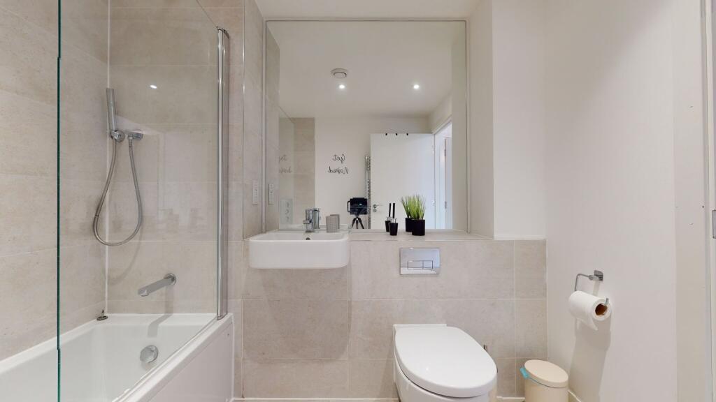 A modern and spotless bathroom suite featuring ...