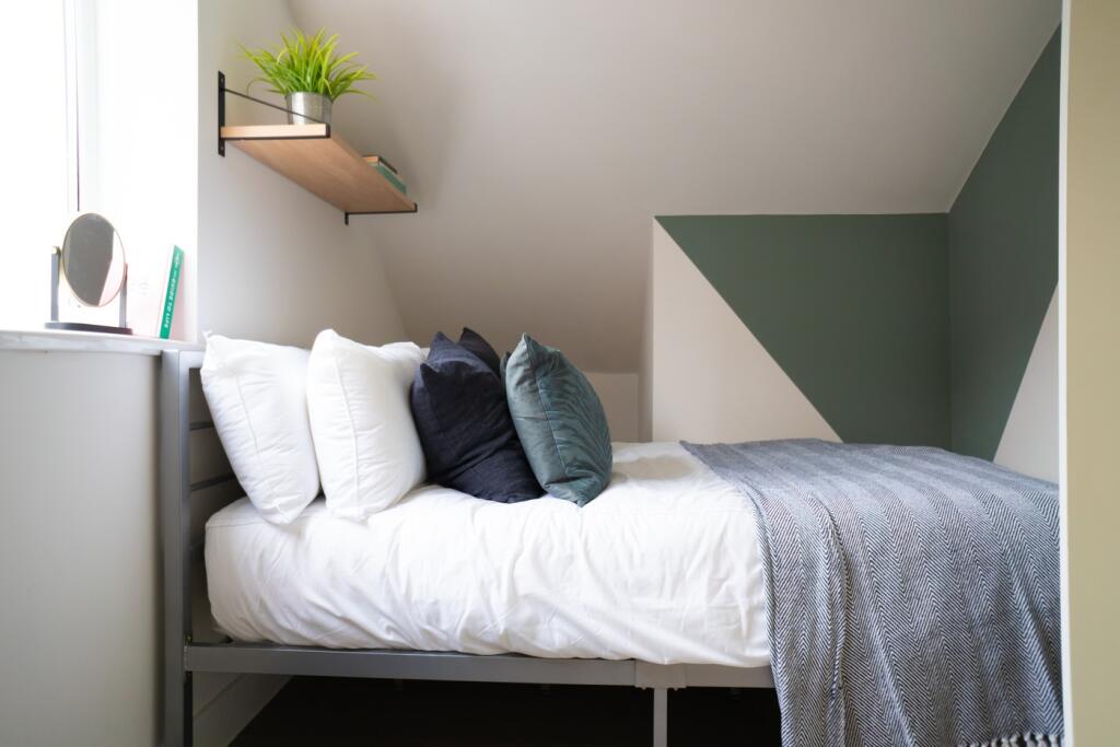 A stylish and cozy double bedroom featuring mod...