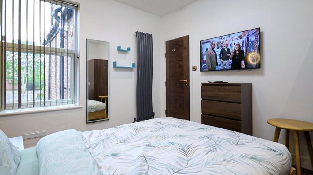 A bright and inviting double bedroom featuring ...