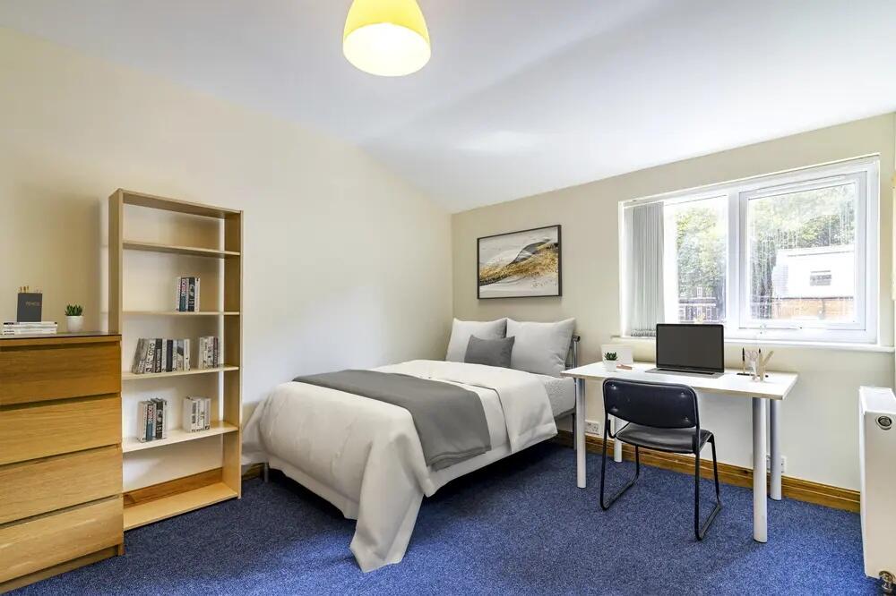 A bright and tidy single bedroom featuring a co...