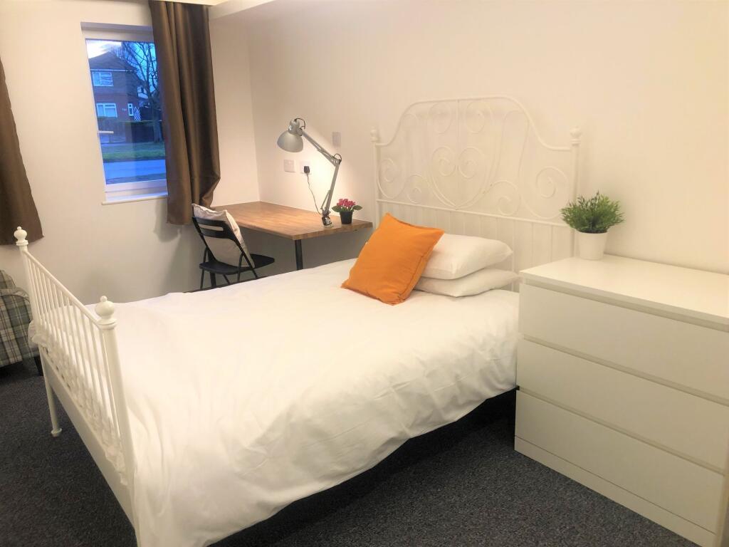 A bright and inviting double bedroom featuring ...