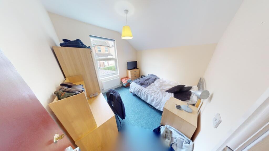 A bright and inviting double bedroom with ample...