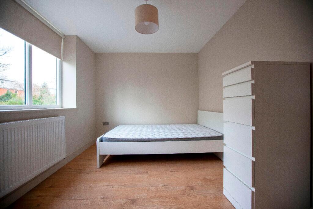 A spacious and well-lit double bedroom offering...