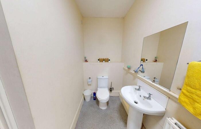 A clean and simple single toilet room featuring...