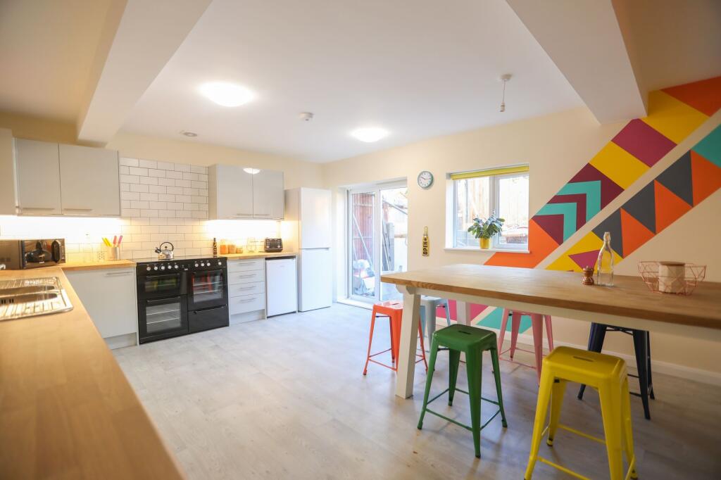 This vibrant kitchen features a spacious layout...