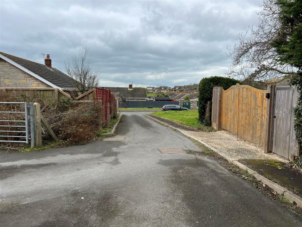 Land looking own roadway showing both vehicle acce