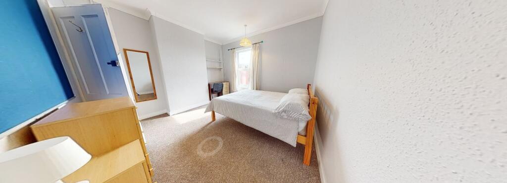 A bright and tidy double bedroom featuring a wo...