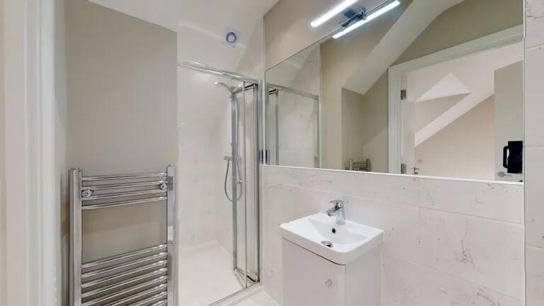 Bright and modern bathroom featuring a sleek sh...
