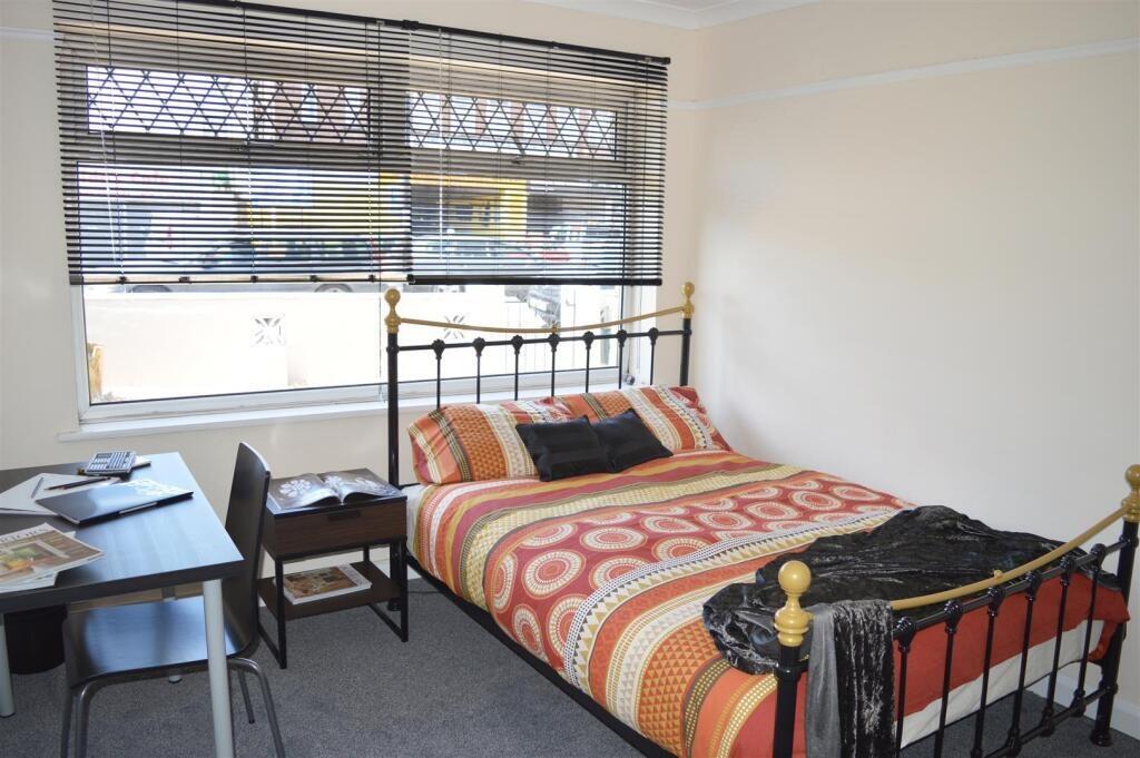 Cozy double bedroom featuring a comfortable bed...