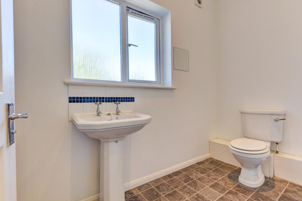 A clean and bright bathroom featuring a white p...