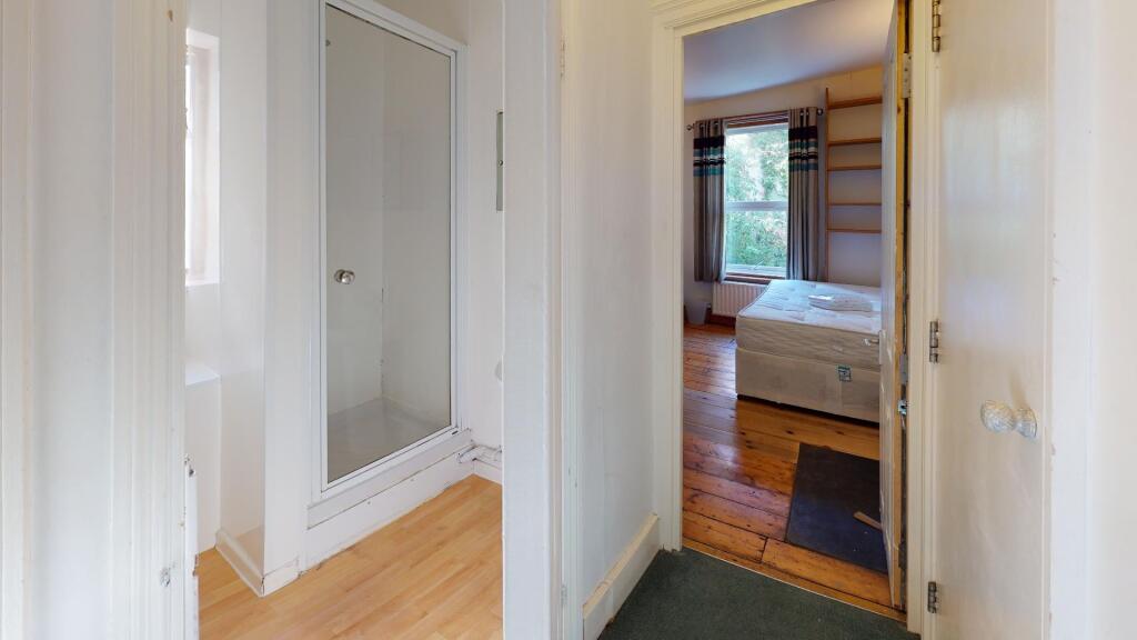 Bright and clean hallway with light wooden floo...