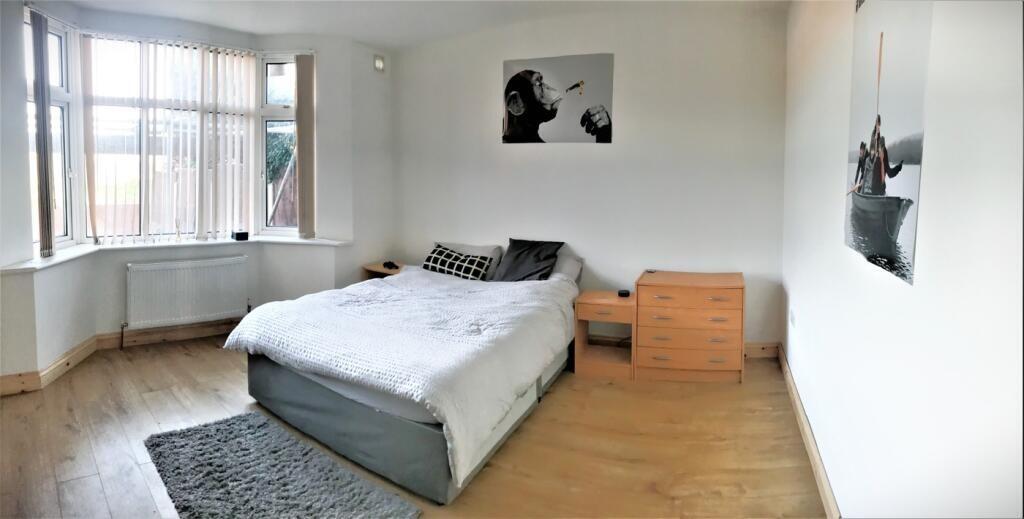 This inviting double bedroom features a comfort...