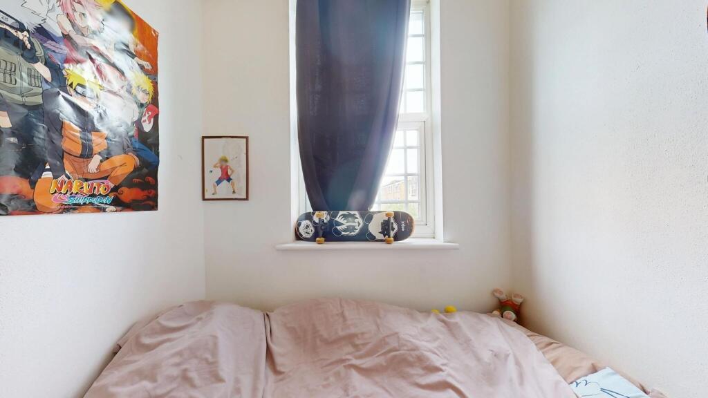 Cozy bedroom featuring soft lighting and a skat...