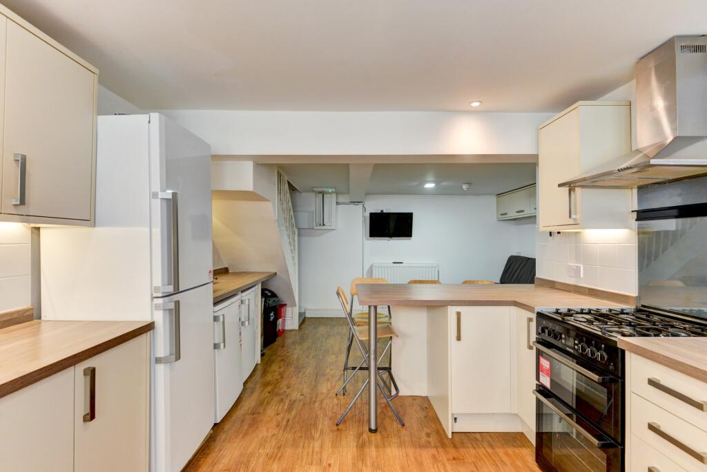 Bright and modern kitchen featuring ample count...