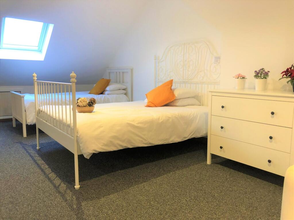 Bright and tidy double bedroom featuring two wh...
