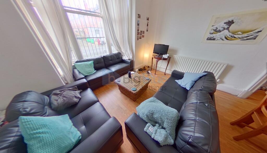 A cozy and inviting living room featuring three...