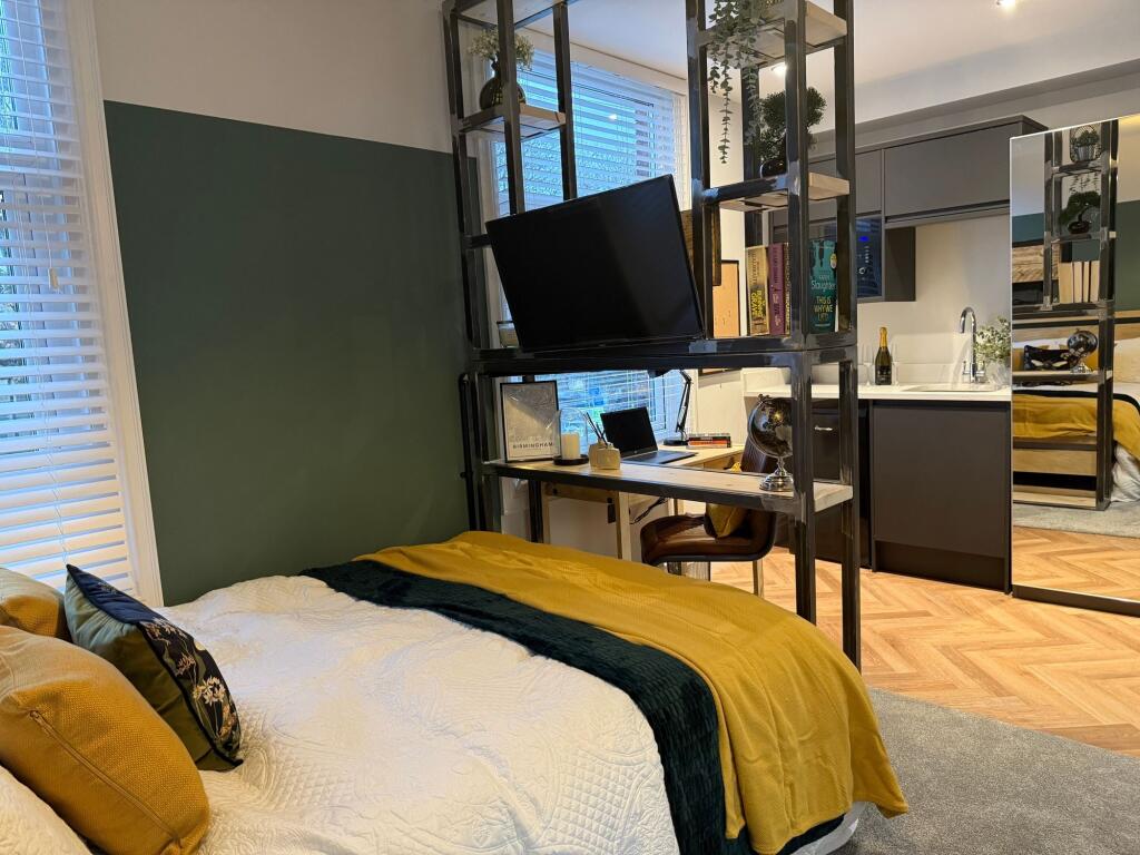 A stylish double bedroom featuring a cozy bed w...