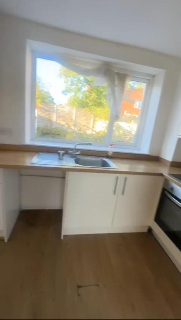 Bright and airy kitchen with a large window all...