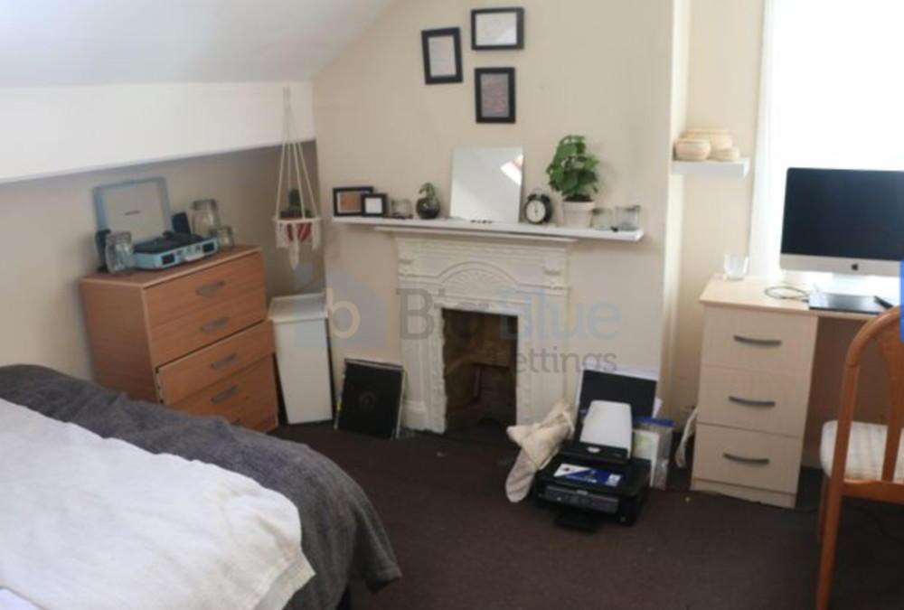 A cozy and well-kept bedroom featuring a double...