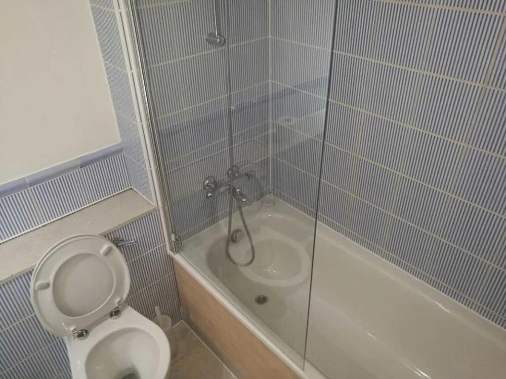 A clean and functional bathroom suite featuring...