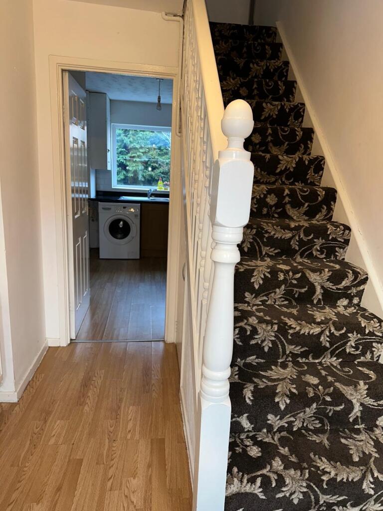 A neat and well-maintained hallway featuring po...