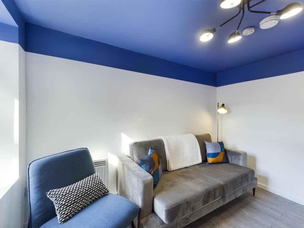 A stylish and inviting living room with modern ...