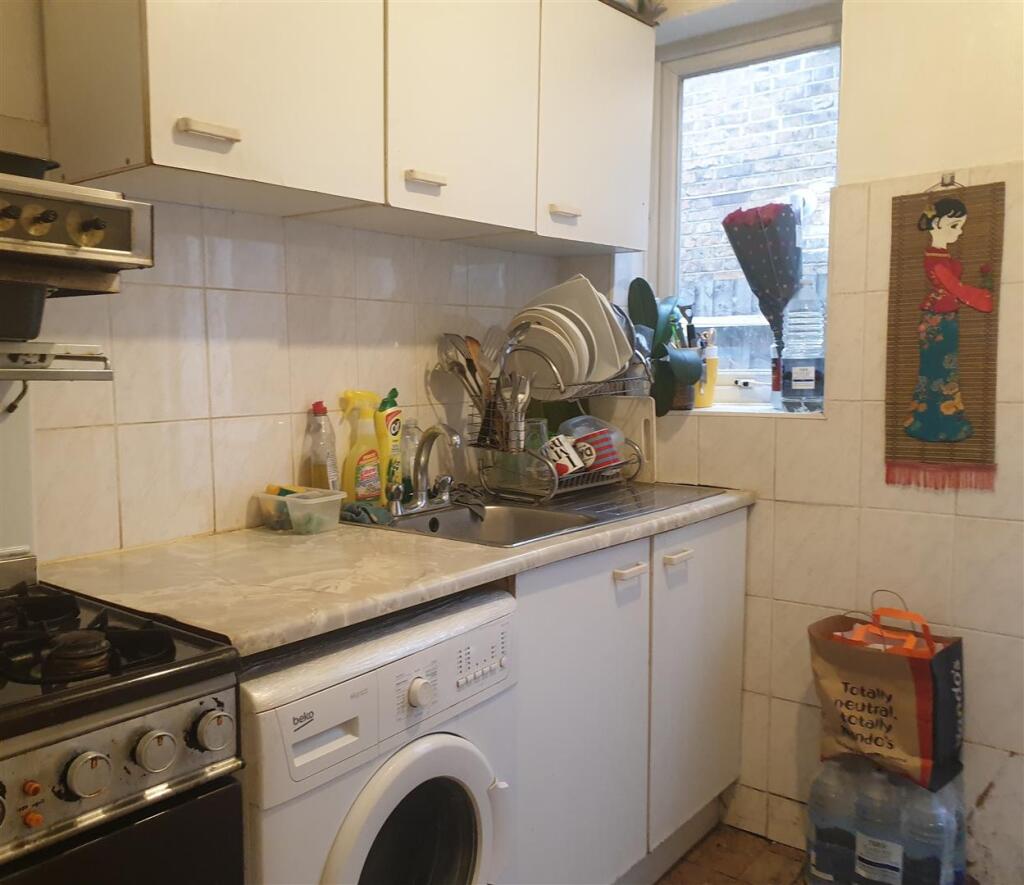 Shared kitchen with two other rooms door leading o