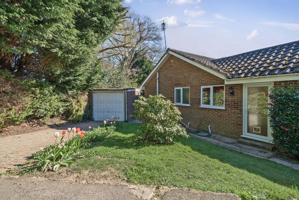 Driveway, Garage and side garden with extension potential to enlarge the kitchen