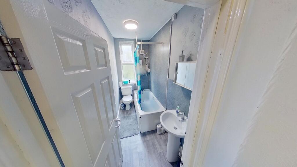 Bright and clean bathroom featuring modern fixt...